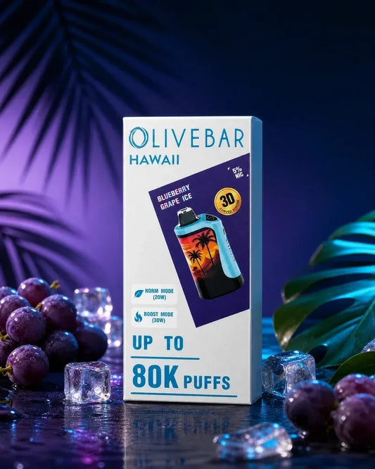 Olivebar Hawaii disposable vape packaging box standing upright on a dark reflective surface, surrounded by purple grapes, ice cubes, and tropical leaves under blue and purple lighting. The box reads 'OLIVEBAR HAWAII', 'BLUEBERRY GRAPE'S ICE', 'UP TO 80K PUFFS', and shows a blue and black vape device with a sunset graphic.